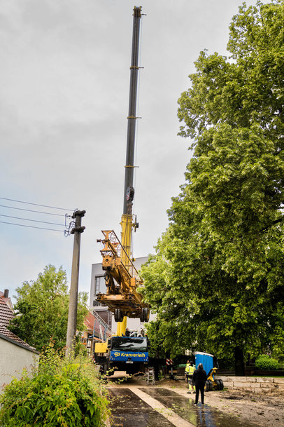 Liebherr's Mobile crane lifts construction crane over treetops